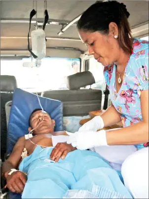  ??  ?? A nurse looks after an injured man after Venezuelan soldiers opened fire on indigenous people near the border with Brazil in Kumarakapa­y, Venezuela. — Reuters photos