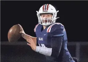  ?? HELEN COMER/THE DAILY NEWS JOURNAL ?? Oakland's Kade Hewitt looks to pass to during the third round of the 6A playoffs against Blackman last Friday.