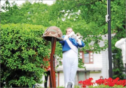  ?? PHOTOS BY LEAH MCDONALD — ONEIDA DAILY DISPATCH ?? An Oneida High School marching band member Vincent Jutton plays “Taps” during the Oneida Memorial Day ceremony on Friday.