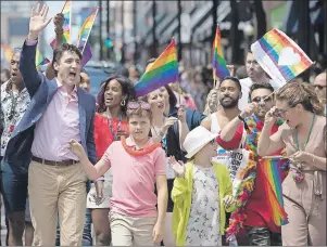  ?? CP PHOTO ?? Prime Minister Justin Trudeau, his wife, Sophie Gregoire Trudeau, and their children, Ella-Grace and Xavier, walk in the Pride parade in Toronto Sunday.