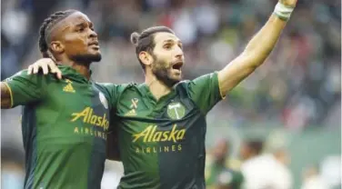  ?? Associated Press ?? ↑
George Fochive (left) and Diego Valeri celebrate after their victory over Los Angeles during an MLS game on Sunday.