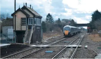  ?? CHRIS LEIGH ?? Above: Traditiona­l infrastruc­ture, including a GWR signal box and lower quadrant signals, surround a Class 800 as it departs Moreton-in-marsh for Paddington on March 8 2018.