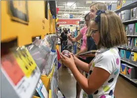  ?? HOLLY SHIVELY / STAFF ?? Susan Bradley and two of her three daughters, Hope and Lily, of Centervill­e, were shopping early for back-to-school supplies on July 16. They said they like to beat the rush on things like folders and use tax-free weekend for clothing.