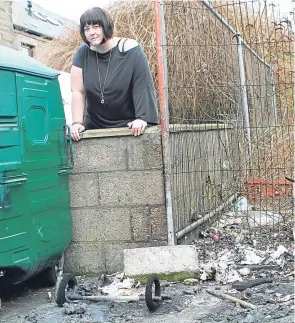  ??  ?? Wendy Sturrock at the spot where the wheelie bins were set alight.