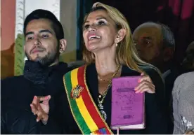  ?? Raldes/AFP/Getty Images ?? Jeanine Áñez, speaks from the balcony of the Quemado Palace in La Paz on 12 November 2019 after proclaimin­g herself the country’s new interim president. Photograph: Aizar