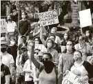  ?? Steve Gonzales / Staff photograph­er ?? Protesters attend a rally last week in Houston in support of amendments to redirect funding to police reforms.