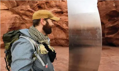  ?? Photograph: @davidsurbe­r_/Reuters ?? David Surber with the monolith in Red Rock Desert, Utah, in this still image obtained from a social media video.