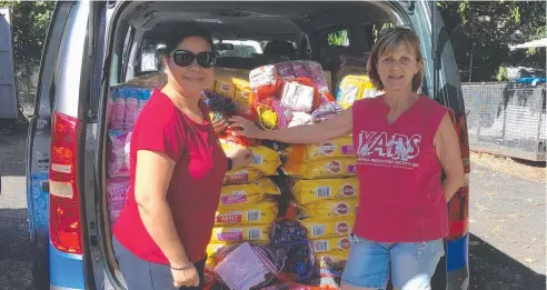  ??  ?? SUPPORT: QITE Work for the Dole Broker Kavita Singh-Ram and YAPS manager Carol Clifton in front of a van full of dog and cat food. The food, as well as bedding, collars and leashes, were made and donated by Work for the Dole Threadworx Activity participan­ts.