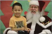  ?? ?? Santa Claus poses with a child at the Trapper School in Nuiqsut, Alaska, on Nov. 29.