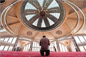  ??  ?? A Chechen Muslim prays in the Aymani Kadyrova Mosque built in hi-tech style in the city of Argun, second largest city of Chechnya.