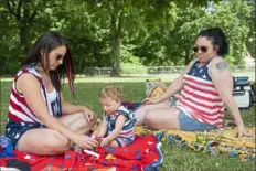  ??  ?? Jaci Eisel, of Port Vue, left, plays with her nephew Dominick Wilson, 1, of North Fayette, while her sister and Dominick’s mother Katie Eisel, of North Fayette, sits nearby Saturday at Point State Park.