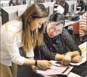  ?? Allen J. Schaben Los Angeles Times ?? A MOTHER and her daughter work on college aid paperwork last week at Garden Grove High School.