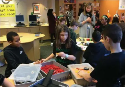  ?? CHAD FELTON — THE NEWS-HERALD ?? Center Elementary fifth-graders Cameron Lewis, left, Olivia Clark and RJ Prosen, right, work in the Engineerin­g Center at the Mayfield Village school’s newly launched Cyclone Creation Station on Jan. 16.