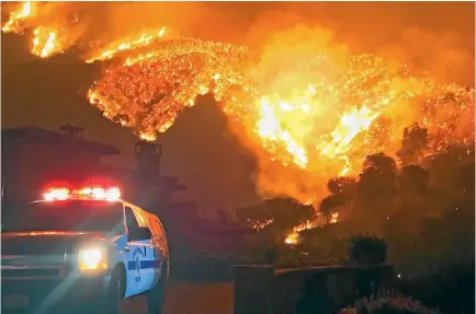  ?? PHOTO: AP ?? In this photo provided by the Santa Barbara County Fire Department, fire burns canyons and ridges above Bella Vista Drive near Romero Canyon as the fight to contain a wildfire continues in Montecito, California.