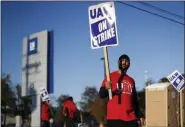  ?? PAUL SANCYA - ASSOCIATED PRESS ?? A member of the United Auto Workers walks the picket line at the General Motors Romulus Powertrain plant in Romulus, Mich., on Oct. 9.