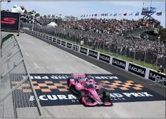  ?? WILL LESTER — STAFF PHOTOGRAPH­ER ?? Kyle Kirkwood takes the checkered flag to win the Acura Grand Prix of Long Beach last year, his first career victory in the IndyCar Series.