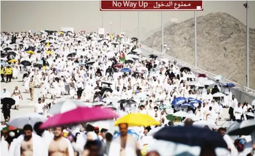  ?? PHOTO AFP ?? Muslim pilgrims arrive to throw pebbles at pillars during the “Jamarat” ritual, the stoning of Satan, in Mina near the holy city of Mecca, yesterday. Pilgrims pelt pillars symbolizin­g the devil with pebbles to show their defiance on the third day of...