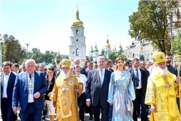  ??  ?? (From second left, front) The head of the Ukrainian Orthodox Church of the Kiev Patriarcha­te Metropolit­an Filaret, Poroshenko and his wife Maryna take part in a procession marking the 1030th anniversar­y of the Christiani­sation of the country, which was...