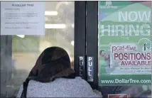  ?? NAM Y. HUH — THE ASSOCIATED PRESS ?? A shopper enters a retail store as a hiring sign shows in Buffalo Grove, Ill. America’s employers added 850,000 jobs in June, well above the average of the previous three months and a sign that companies may be having an easier time finding enough workers to fill open jobs.