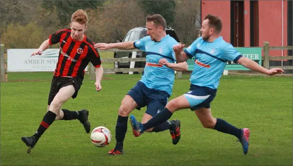  ??  ?? Paul Brennan of Gorey Rangers in a race for possession with Rathkeale F.C. duo Mickey Lyons and Thomas Quilligan during their FAI Junior Cup match.