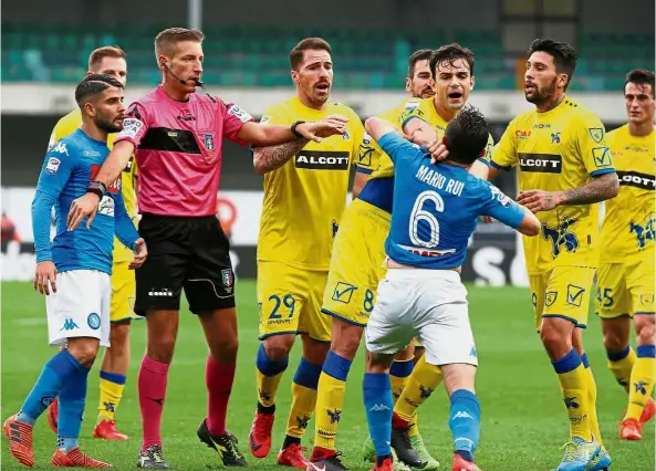  ??  ?? Boiling point: Napoli’s Mario Rui clashing with Chievo’s Ivan Radovanovi­c in the Serie A match on Sunday. — Reuters