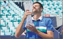  ?? (AP) ?? Hubert Hurkacz of Poland poses with the trophy after defeating Yannik Sinner of Italy during the finals of the Miami Open tennis tournament, on April 4, in Miami Gardens, Florida.