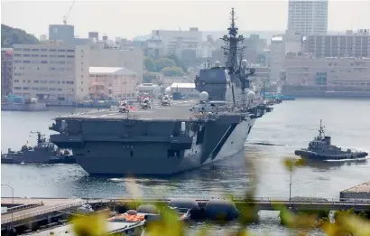  ?? AFP ?? Japan’s Maritime Self Defence Forces helicopter carrier Izumo sails out of its Yokosuka base in Kanagawa prefecture on Monday. Japan dispatched its biggest warship since World War II to protect a US supply ship as tensions mount in the region over...