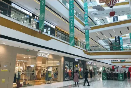  ?? (Stella Qiu/Reuters) ?? SHOPPERS ARE seen inside the Wanda Plaza in Xinxiang last month. Until now, China’s consumptio­n has been led by residents of the capital and free-spending coastal cities. But the hinterland has been catching up fast, transforme­d by industrial­ization...