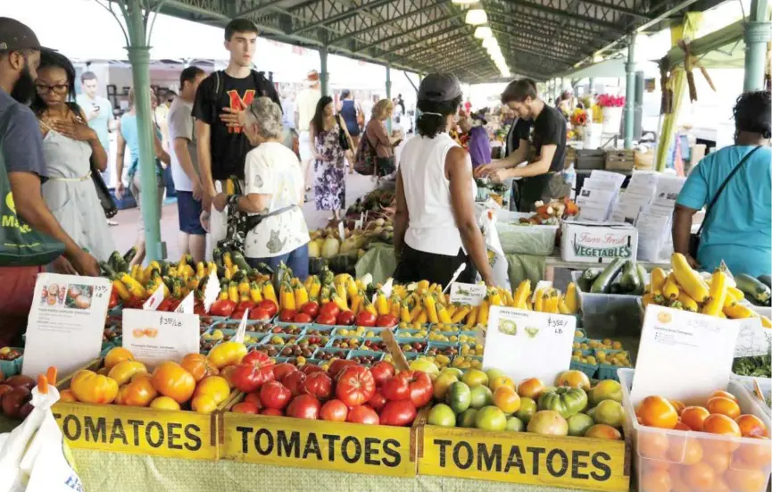  ??  ?? ↑
People shop at a farmer’s market in the Capitol Hill, Washington.
Reuters