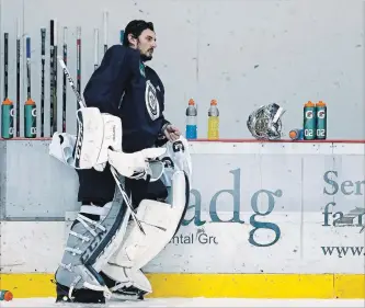  ?? JOHN WOODS
THE CANADIAN PRESS ?? Winnipeg Jets goaltender Connor Hellebuyck takes a break during practice in Winnipeg on Monday ahead of their opening playoff round against the Minnesota Wild and his friend Devan Dubnyk.