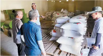  ?? Courtesy of Ministry of Land, Agricultur­e and Rural Affairs ?? Officials from the office of the Korea Partnershi­p for Innovation of Agricultur­e in Senegal check rice seed sacks in Sapu, Gambia, in this March file photo.
