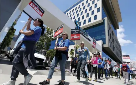 ?? Tribune News Service/los Angeles Times ?? Striking Writers Guild of America workers picket outside the Sunset Bronson Studios on May 2 in Los Angeles.
