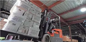  ?? GERRY BROOME/AP ?? A forklift operator loads absentee ballots for mailing this month in Raleigh, North Carolina.