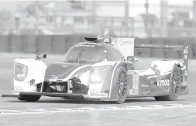  ?? ASSOCIATED PRESS ?? From Formula One to Imsa ; Formula One Star Fernando Alonso, of Spain, co-driver of the United Autosports Ligier LMP2 walks to his garage during testing for the IMSA 24 hour auto race at Daytona Internatio­nal Speedway, in Daytona Beach, Fla.