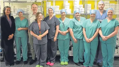  ??  ?? Mr Edward Dunstan, third left, with members of his orthopaedi­c surgery team. New statistics show the Fife board is among the top performing in Scotland for elective orthopaedi­c surgery.
