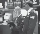  ?? JOHANNES EISELE, AFP/ GETTY IMAGES ?? Traders works after the opening bell at the New York Stock Exchange ( NYSE) on Wall Street, on Aug. 1, 2019.