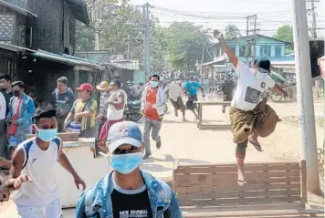  ?? GETTY/AFP ?? Protesters run from police Friday during a crackdown on demonstrat­ions against the military coup in Naypyidaw, Myanmar. Also on Friday, Myanmar’s U.N. ambassador, Kyaw Moe Tun, strongly appealed for the “strongest possible action from the internatio­nal community” to immediatel­y restore democracy during a speech to the U.N. General Assembly.