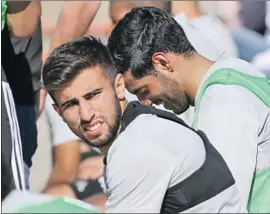  ?? Reed Saxon Associated Press ?? DIEGO ROSSI, left, sits next to Carlos Vela at UCLA during the first day of training camp for LAFC, a long way from home for the 19-year-old Uruguayan.