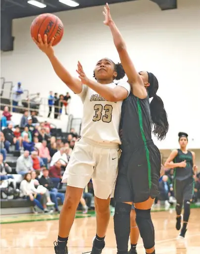  ?? STAFF PHOTO BY ROBIN RUDD ?? Bradley Central’s Jamaryn Blair (33) goes in for a layup and is fouled by East Hamilton’s DeZah Lacy during the Region 3-AAA championsh­ip game Wednesday night at Rhea County. Blair scored 16 points as Bradley won 74-31.