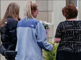  ??  ?? Flowers: Mourners at the scene in Calne, Wiltshire, yesterday