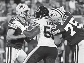  ?? NUCCIO DINUZZO/CHICAGO TRIBUNE ?? This outside pressure by Khalil Mack pushed Aaron Rodgers into a vulnerable position in the pocket Sunday, allowing Roy-Robertson Harris to fly through the middle for a sack.