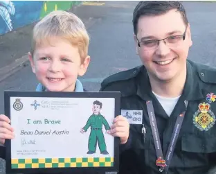  ??  ?? Four-year-old Beau Austin with Ashley Page, a 999 emergency medical services call taker at Welsh Ambulance Service