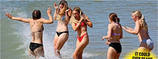  ?? ?? Thank God it’s Fry-day! A group of friends take a dip in the surf at Bournemout­h beach yesterday