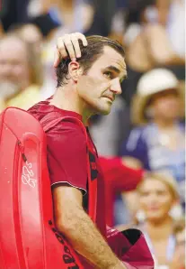  ?? AP FOTO ?? UPSET. Roger Federer walks out of the court disappoint­ed after an early exit in the U.S. Open in New York.