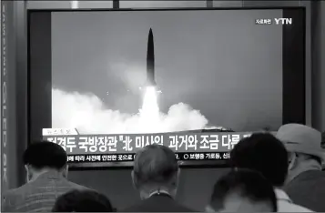  ?? ASSOCIATED PRESS ?? PEOPLE WATCH A TV showing a file image of North Korea’s missile launch during a news program at the Seoul Railway Station in Seoul, South Korea, Wednesday. North Korea on Wednesday fired several unidentifi­ed projectile­s off its east coast, South Korea’s military said, less than a week after the North launched two short-range ballistic missiles into the sea in a defiance of U.N. resolution­s. The signs read: “North Korea’s missile is a bit different from the past.”