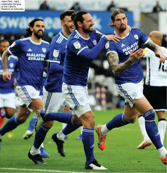  ??  ?? Aden Flint, right, celebrates his goal at the Liberty Stadium on Saturday