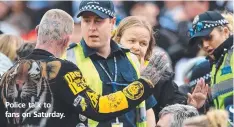  ??  ?? Police talk to fans on Saturday.