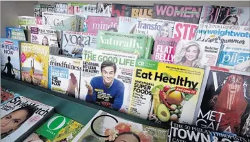  ?? Glenn Koenig Los Angeles Times ?? A SELECTION of magazines at the stand. “It’s an integral part of the Brentwood community,” said Leonard Frank, a longtime customer of the stand. “I don’t think Whole Foods understand­s the community.”