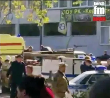  ?? KERCH FM NEWS VIA AP ?? In this image made from video, showing the scene as emergency services load an injured person onto a truck, in Kerch, Crimea, Wednesday. An explosive device has killed several people and injured at least 50 others at a vocational college in Crimea Wednesday in what Russian officials have called a possible terrorist attack.