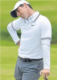  ?? Pictures: Getty/PA. ?? Join leader Padraig Harrington, top, hits his second on the ninth hole; above: Rory McIlroy reacts to a missed putt on the 18th; Russell Knox tees off on the fourth.